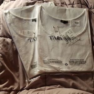 Two plain white tank tops
